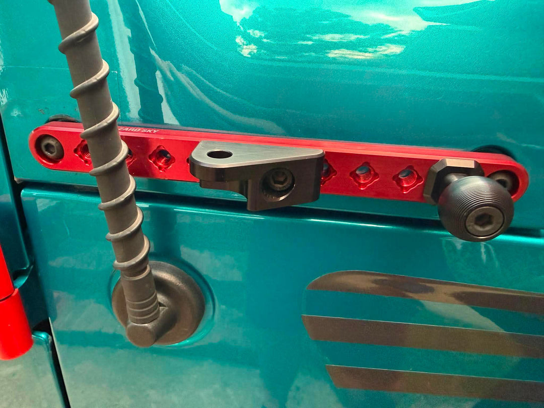 Red anodized HazardKey cowl side rail on a teal Jeep Wrangler JL with a black light mount and 1 inch ball mount