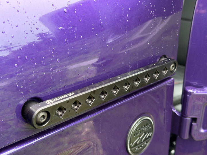 Close up of HazardKey key slots along a cowl side rail on a purple Jeep Wrangler JL