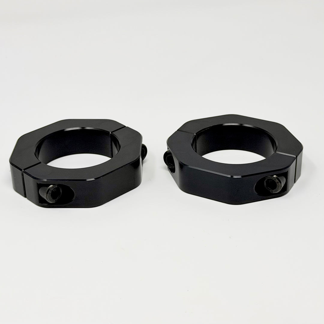Pair of black anodized billet aluminum strut reinforcement collars for Jeep Cherokee KL lift kits