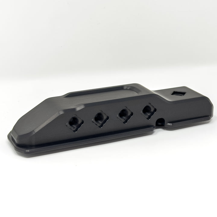Black anodized HazardKey billet hood bumper showing key slots and wire passthrough for Jeep JL and JT